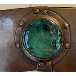 Liberty & Co, Arts and Crafts hammered copper framed oval wall mirror, mounted by four turquoise Ruskin cabochon roundels, with ivorine maker's label verso
