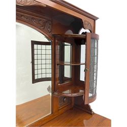 Late Victorian walnut mirror back sideboard or dresser, the raised back fitted with two curved and lead glazed cabinets, central arched bevelled mirror, the sideboard with break bowfront, fitted with six drawers and two cupboards, the cupboard doors panelled and carved with scrolls, shell and plant motifs, shaped apron with cabriole feet
