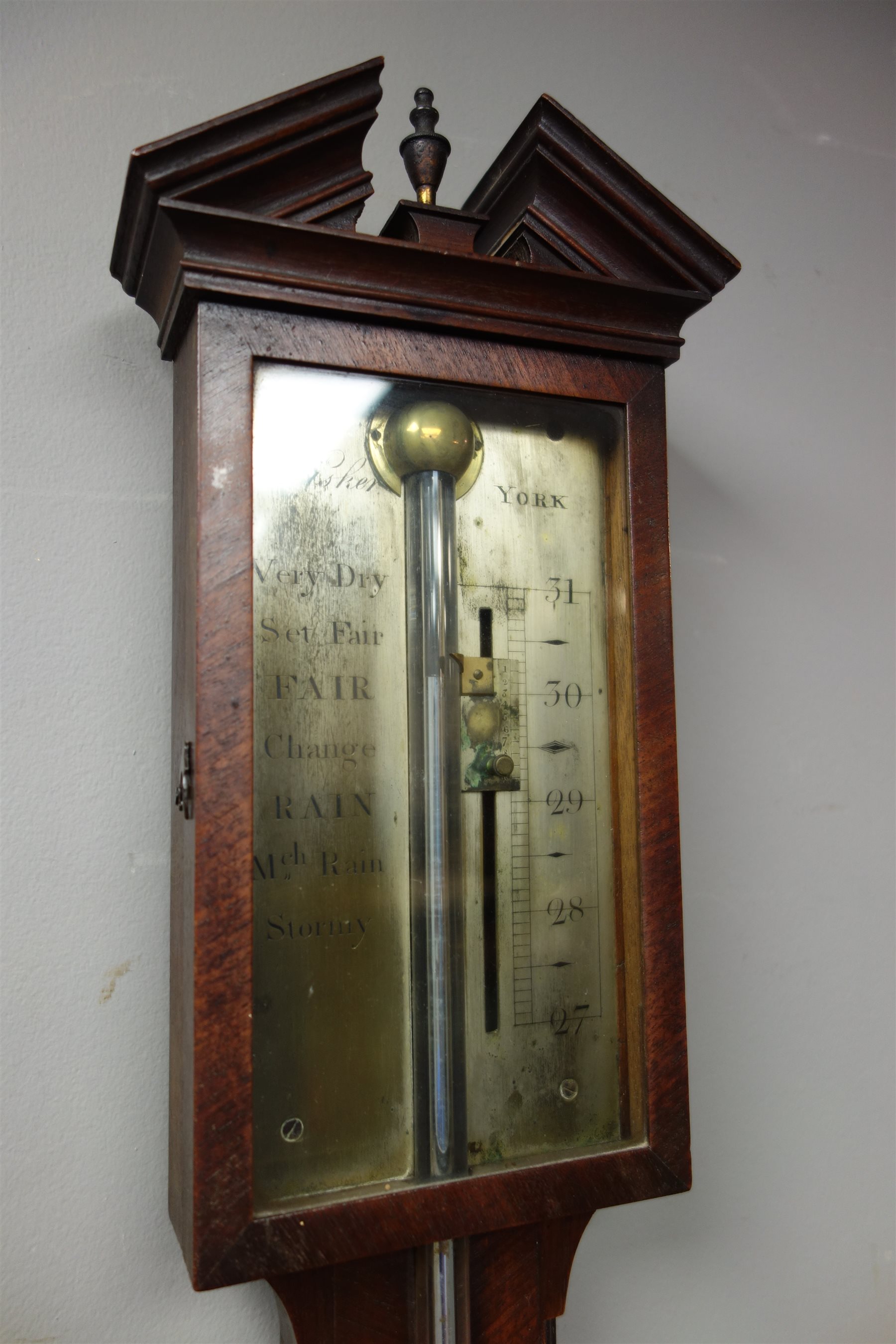 III mahogany mercury stick barometer, broken arch pediment above glazed door with