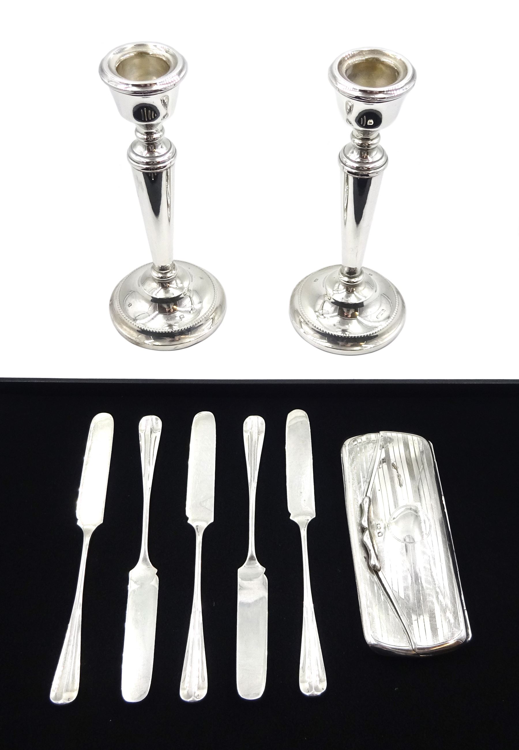 Pair of silver candlesticks by P H Vogel & Co, Birmingham 1970, silver spectacle case by W J Myatt & Co, Birmingham 1920 and five silver butter knives by James Dixon & Sons Ltd, Sheffield 1919