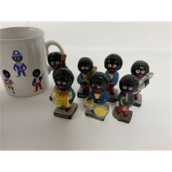Fourteen Golly Band figures, eight labelled Robertson to base, and TAMS golly mug