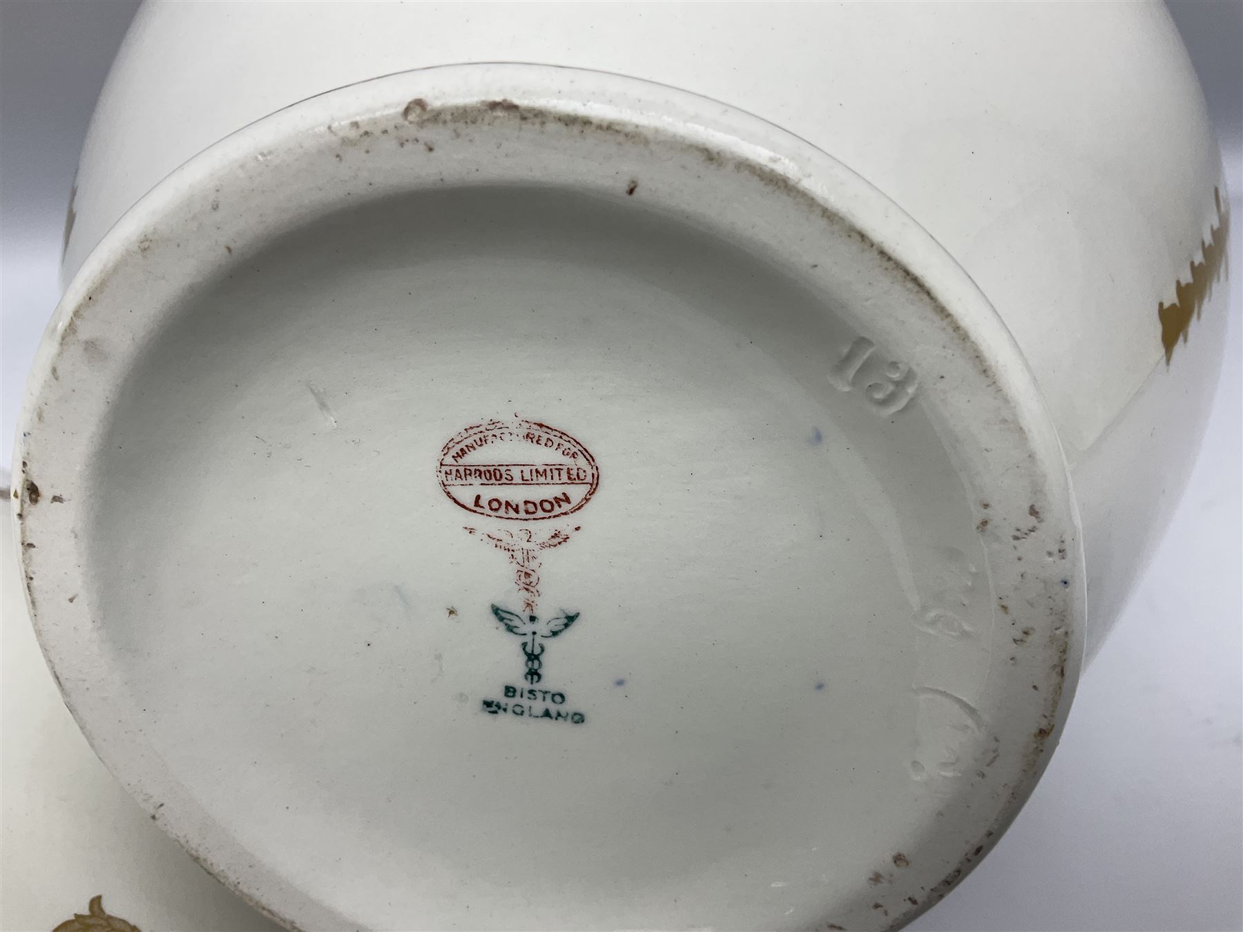 Early 20th century Bishop and Stonier four piece toilet set, comprising washbowl, wash jug, toothbrush pot, and chamber pot, each  decorated with deep blue band and husk swags and festoons in gilt, with printed Caduceus Bisto marks beneath and printed retailers mark 'Manufactured for Harrods Limited London', wash bowl D43cm, wash jug H31.5cm