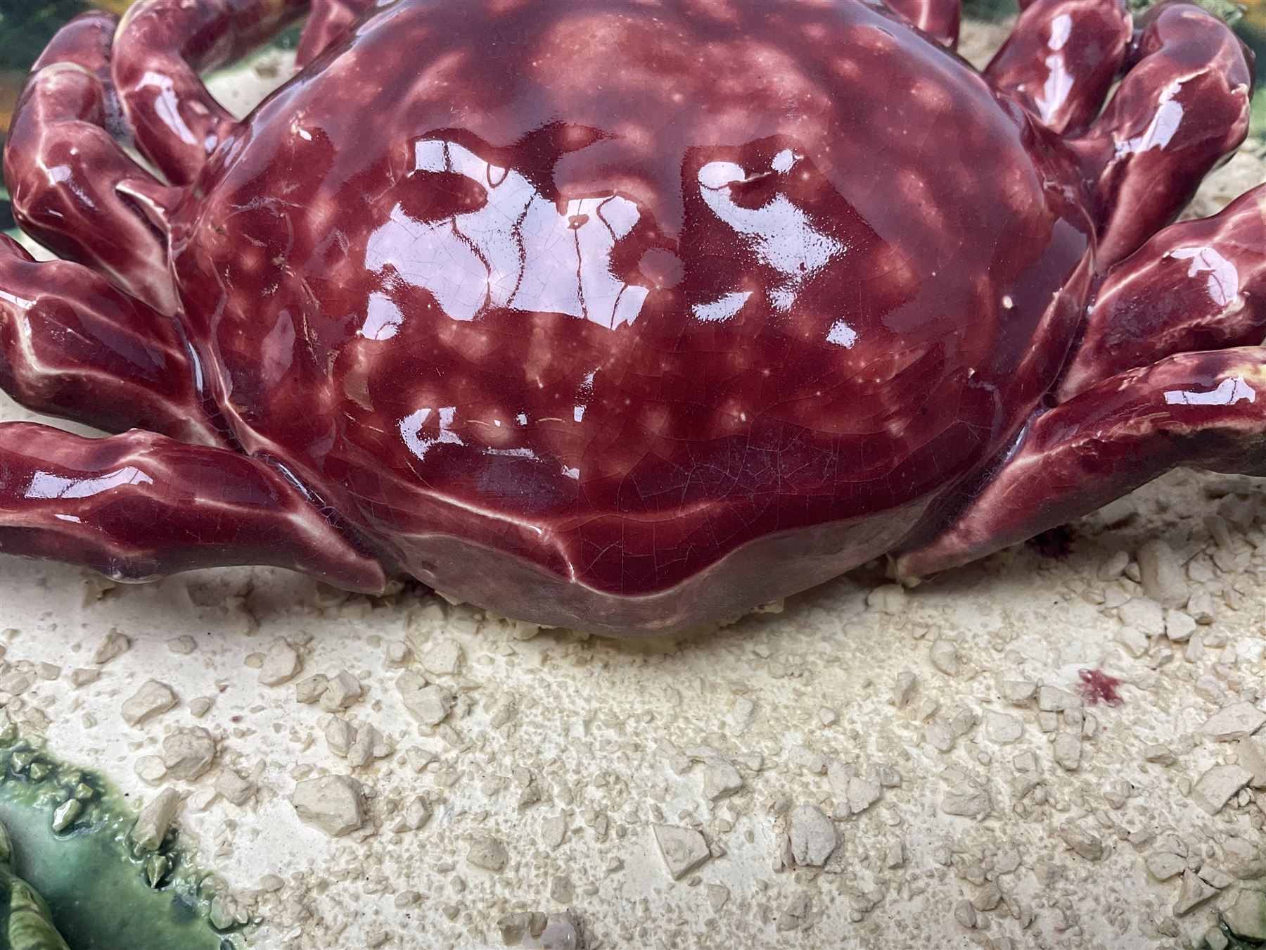 Two 20th Century Portuguese Palissy style Majolica wall plates, one depicting a crab, the other a lobster each to the centre modelled in relief surrounded by encrustations and shells, both with impress marks beneath, D32cm