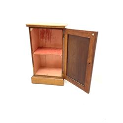 Early 20th century elm bedside cabinet, panelled cupboard door enclosing single shelf, platform support 