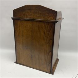 Edwardian oak smokers cabinet with the single glazed door to fitted interior having a single draw and pipe rack, H40cm