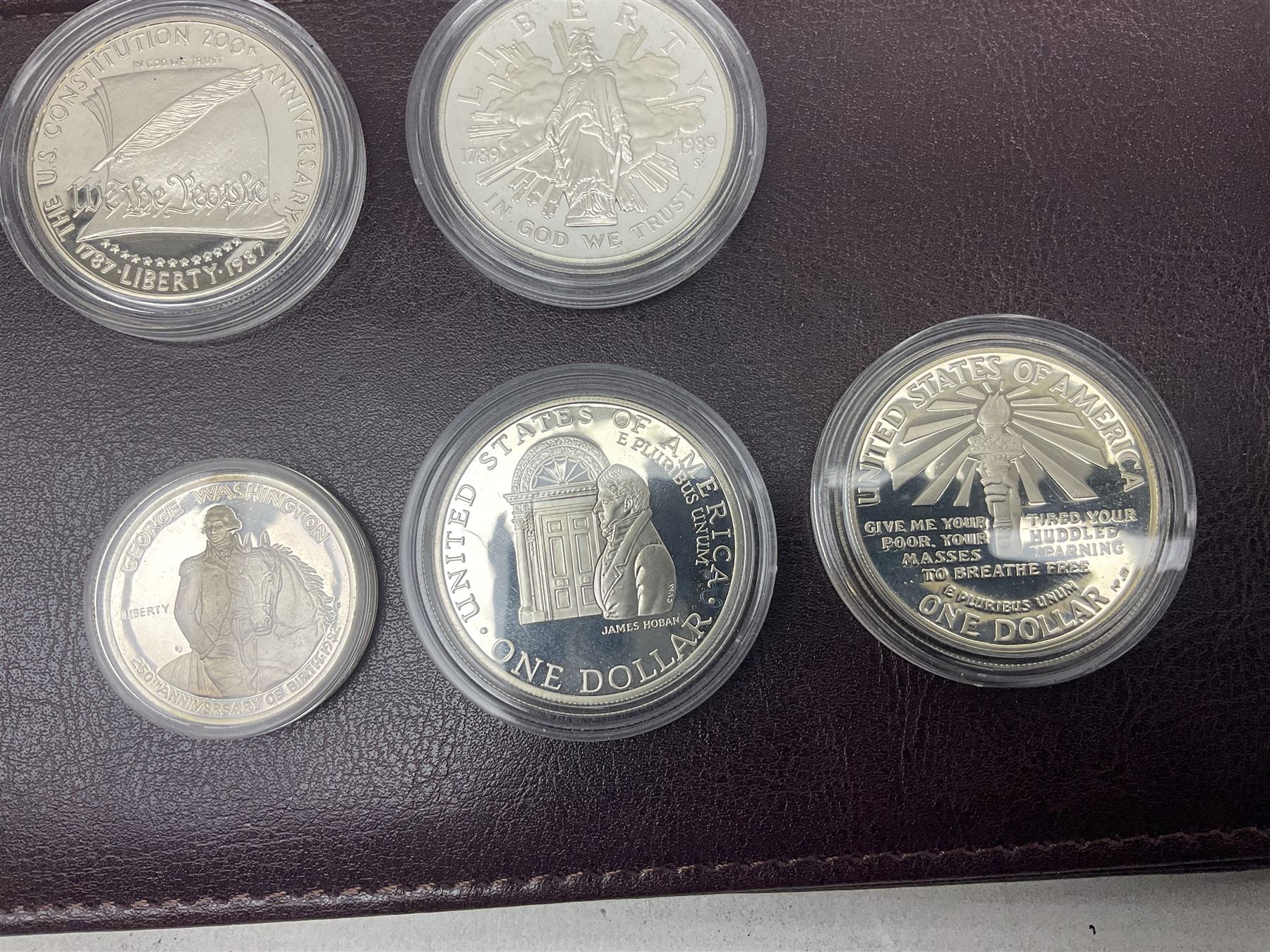 Five United States of America commemorative silver proof coins, comprising 1986, 1987, 1989, 1992 one dollars and 1982 half dollar, all with certificates