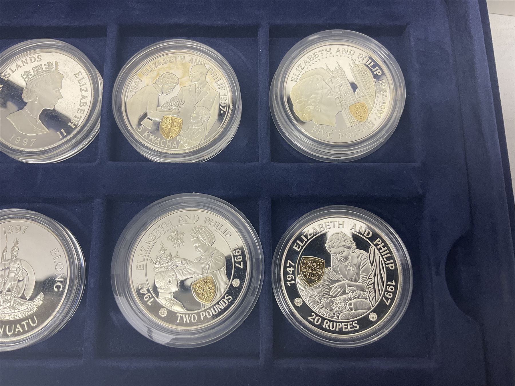The Royal Mint Golden Wedding Anniversary silver proof coin collection, comprising twenty-four international commemorative coins, cased with certificates