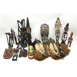 African carved wood figures, various masks including painted examples and other similar items 