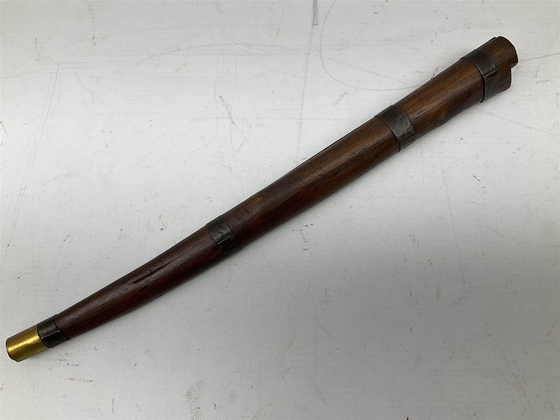 19th century Algerian Flyssa long knife, the 34cm single edged pointed decorative blade inset with yellow metal, chased brass grip with pommel as the snout of a stylised animal and carved hardwood scabbard L45cm overall