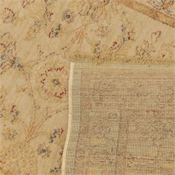 Cream ground wool rug, with faded floral medallion and scrolling foliate design, enclosed by matching floral border in beige, soft red and blue tones
