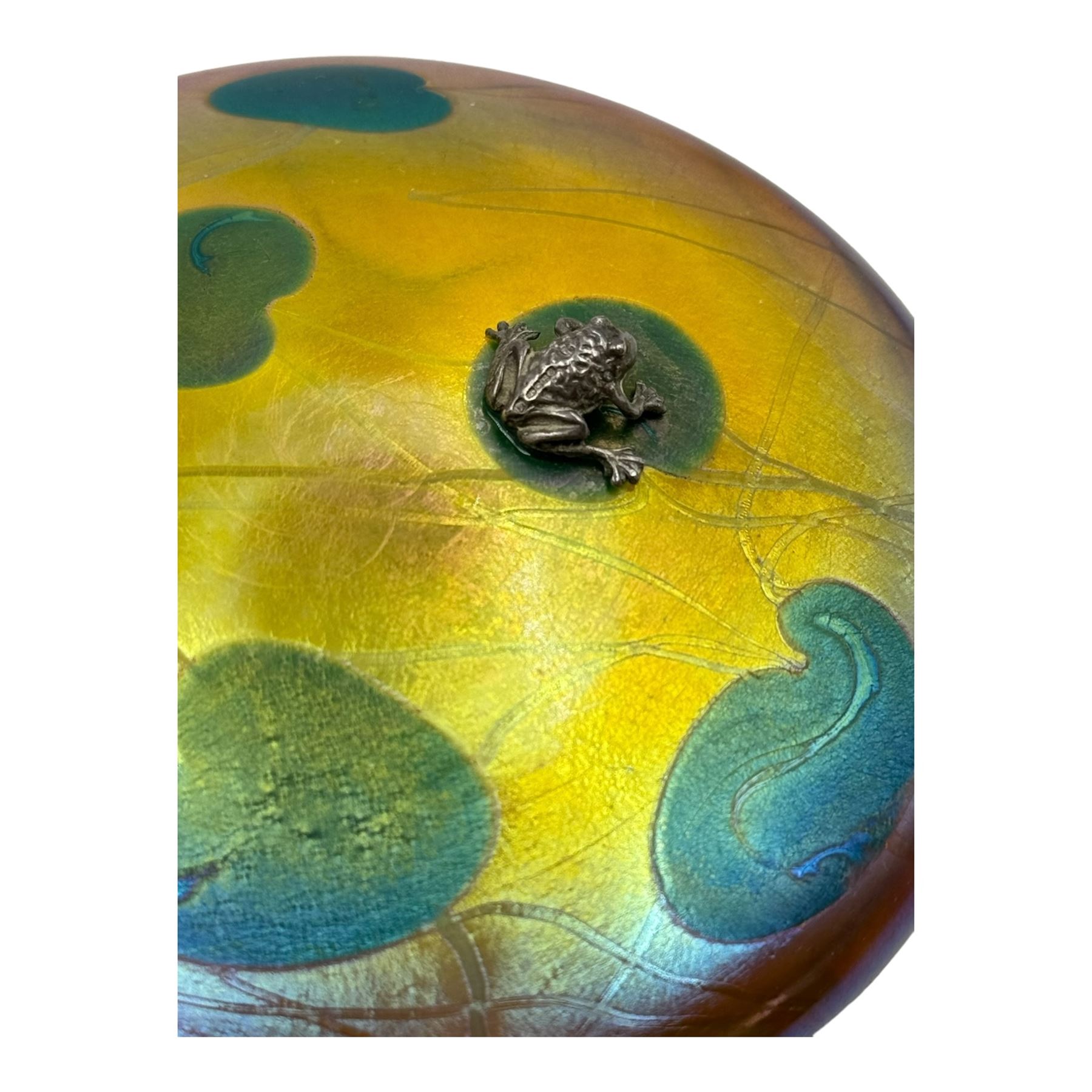 John Ditchfield for Glasform disc paperweight in iridescent yellow with green lily trail and silver hallmarked frog to top, D13cm