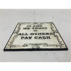 Cast iron 'In God we Trust' sign with black writing on a white ground, H15cm