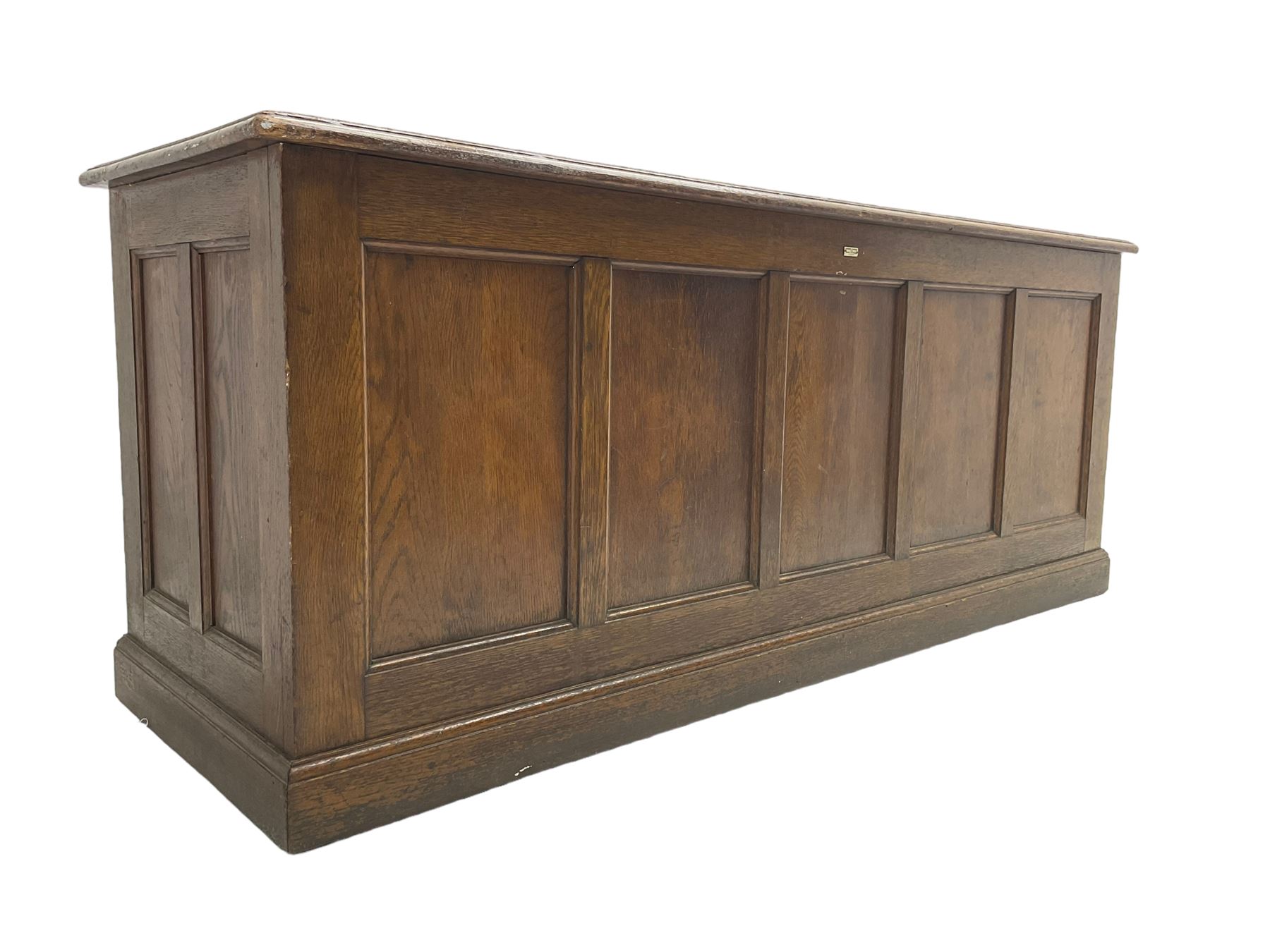 Illingworth Ingham and Co. School Furnishers (Leeds c1900) - early 20th century oak rostrum or headmaster's desk, rectangular top, the front and sides panelled with open reverse, on plinth base