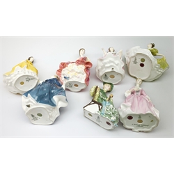 A group of seven Royal Doulton figurines, comprising Southern Belle HN2229, A Hostess of Williamsburg HN2209, Ballad Seller HN2266, Coraline HN2307, Fragrance HN2334, Ascot HN2356, Lynne HN2329. (7). 