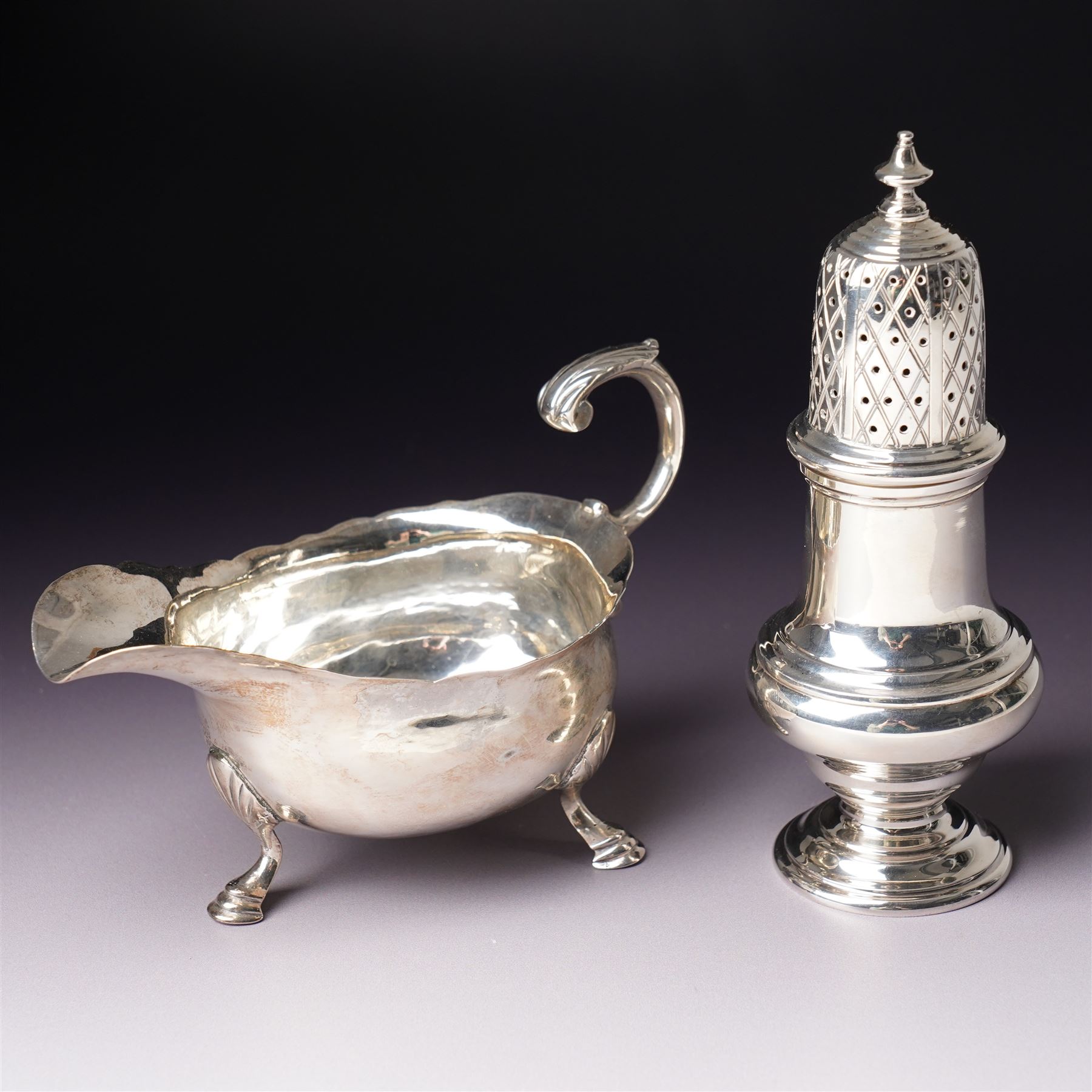 Silver vase shape sugar caster H15cm London 1975 Maker C J Vander Ltd and a George III silver sauce boat with crimped rim and 'C' scroll handle London 1763 Maker possibly William Skeen
