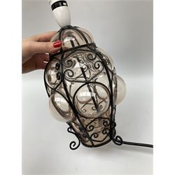 Continental glass ceiling light encased in an iron frame with scroll design H35cm, along with a matching table lamp H35cm, with a cream lampshade with tassel detail.  