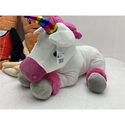 Three large ALDI Kevin carrots and giant unicorn stuffed toy together with quantity of smaller carrots
