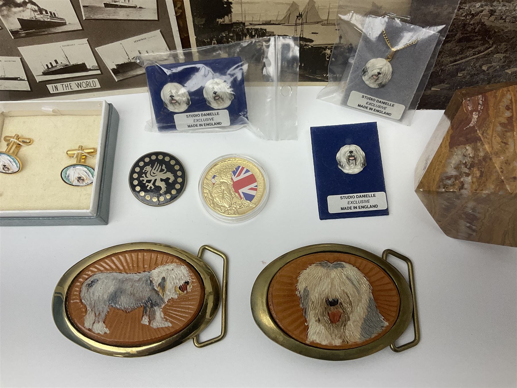 Studio Danielle Old English Sheepdog jewellery including two pairs of cufflinks, necklace and pin, together with similar belt buckle, hardstone tetradecahedron paperweight, postcards and an Imperial War Museum Falklands Conflict coin
