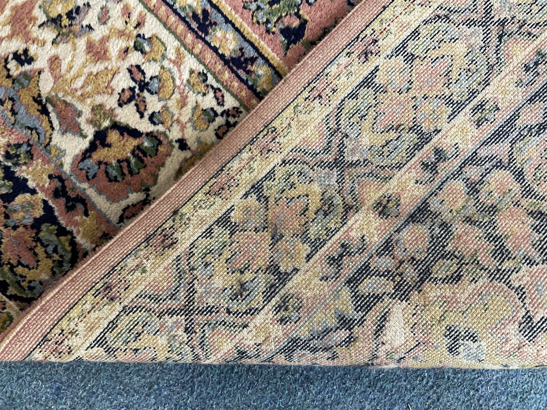 Large Persian design peach ground carpet, the field decorated with floral medallion, multi-band border decorated with repeating flower head pattern