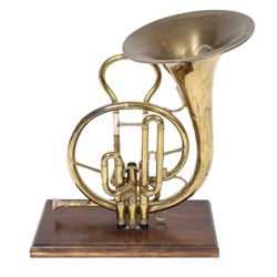 Boosey & Co Ltd French horn, converted into a table lamp, upon a wooden plinth, H45cm