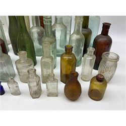 Collection of various vintage glass bottles and stoppers, including advertising bottles, sauce bottles and medical bottles etc