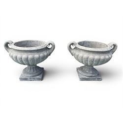 Pair of squat cast stone garden urns of kylix form, gadrooned body with twin pierced scrol...