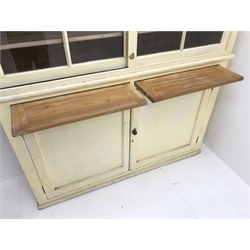  Mid century large painted butler unit, projecting cornice, two sliding glazed doors enclosing three shelves above two slides and two cupboard doors, plinth base, W158cm, H184cm, D41cm  