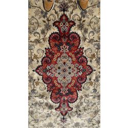 Central Persian Kashan rug, ivory and teal ground, overall geometric design, angular interlaced decorated field with stylised plant motifs, crimson ground, central medallion, the crimson main border band decorated with geometric motifs