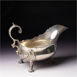 Late Victorian silver sauceboat with crimped rim, C scroll handle on shaped supports Sheff...