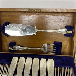 Canteen of silver plated fish knives and forks, with ornate foliate decoration housed in canteen with hinged two tier interior