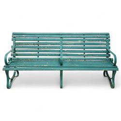 Early 20th century green painted wrought iron and slatted wood garden bench, with scrollin...