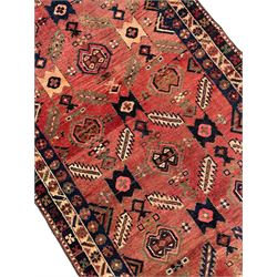 Near pair of Persian Azerbaijan red ground runners, each rug decorated with Nazarlik and stylised leaf motifs, enclosed with three band border decorated with flower heads and geometric motifs 

406cm x 99cm 
409cm x 102cm
