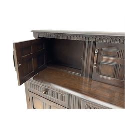 Dark oak drawer leaf dining table with four hoop and wheel back chairs; and similar court cupboard
