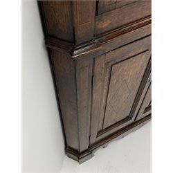 George III oak floor standing corner cabinet, scrolled swan neck pediment with central finial over astragal glazed door, painted interior fitted with three shaped shelves, the lower section fitted with single shaped shelf enclosed by two fielded panel doors inlaid lozenges, on bracket feet, H195cm, W77cm