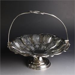Edwardian silver swing handled basket, of circular form with shaped rim and engraved floral and foliate decoration, with know design swing handle and upon circular stepped pedestal, hallmarked J Sherwood & Sons, Birmingham 1901, H9cm, D22cm