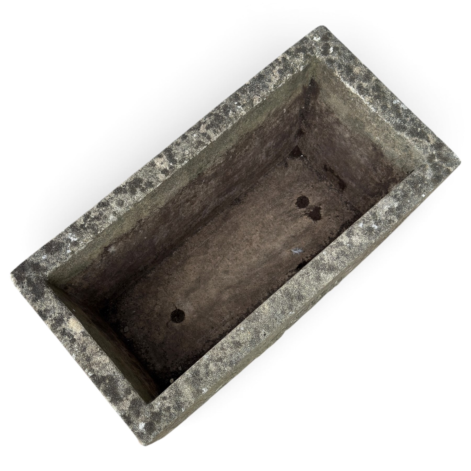 Two weathered composite stone garden trough planters, comprising a low serpentine trough relief moulded with rocaille, shell and foliate ornament (W55cm D32cm H19cm); the plain rectangular trough decorated with four moulded Yorkshire rose medallions to each side (W51cm D26cm H25cm)