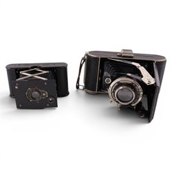 Three cameras, including Kodak Vest Pocket Camera A-127, Zenit E and a Hapo 10 and a Smiths Empire pocket watch 