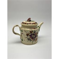 18th century creamware teapot, probably Leeds, with reeded entwined handle and floral finial to the cover, the body with hand painted polychrome decoration of figure to one side, and floral spray to the other, collectors paper label beneath inscribed Leeds Pottery, H11.5cm