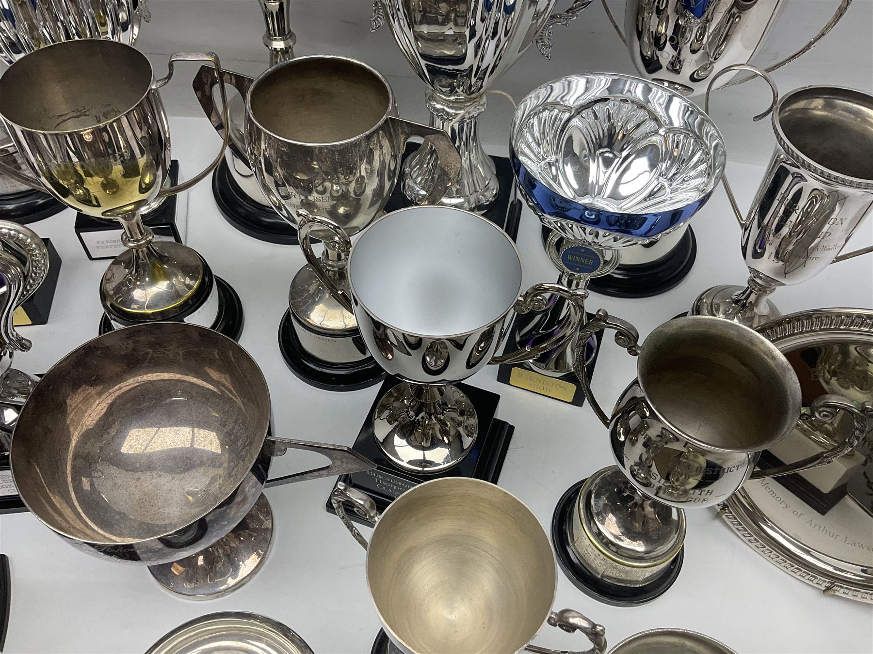 Collection of silver plated and metal trophy cups and winners plaques, all relating to the Burniston and District Show, most engraved with competitions and winner's names, in three boxes 