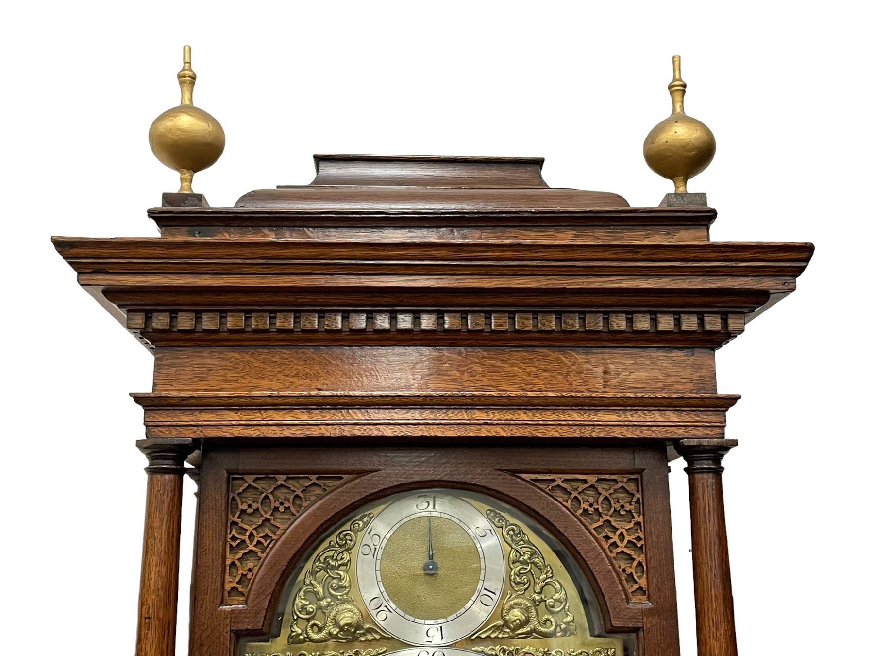 Henry Hindley of York – mid-18th century oak cased 8-day longcase clock,
flat topped caddy pediment with gesso finials, rectangular hood door flanked by wooden turned pilasters with capitals, canted trunk with a full-length break arch topped door on a short plinth with applied skirting and bracket feet, brass dial with a silvered chapter ring, Roman numerals and five-minute Arabic’s, minute and inner quarter hour tracks, matted dial centre with subsidiary seconds dial, blued steel hands and female head pattern spandrels, silvered calendar dial to the break arch with dolphin spandrels, four pillar rack striking movement, striking the hours on a bell. With weights and pendulum. 
H250 W48 D27
Henry Hindley originally from Wigan (Lancs) is recorded as working in York from Petergate 1731-41 then Stonegate 1741-1771. A famous and highly innovative maker, often referred to as the “Tompion of the North.” 
