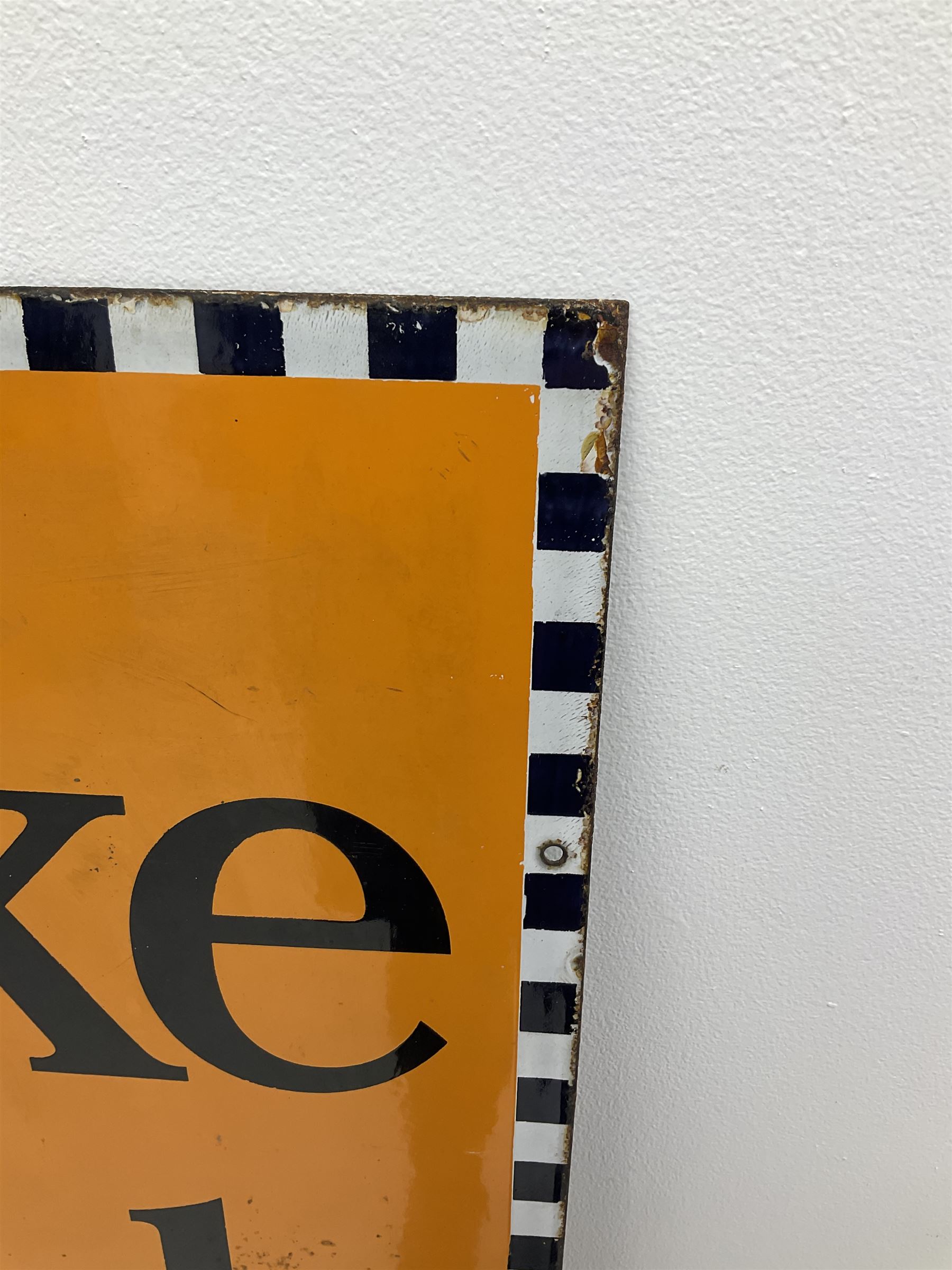 A large enamel advertising sign for Brooke Bond tea, detailed 'Brooke Bond Tea is good tea' in black lettering upon an orange ground with black and white chequered border, H101.5cm, W76cm. 