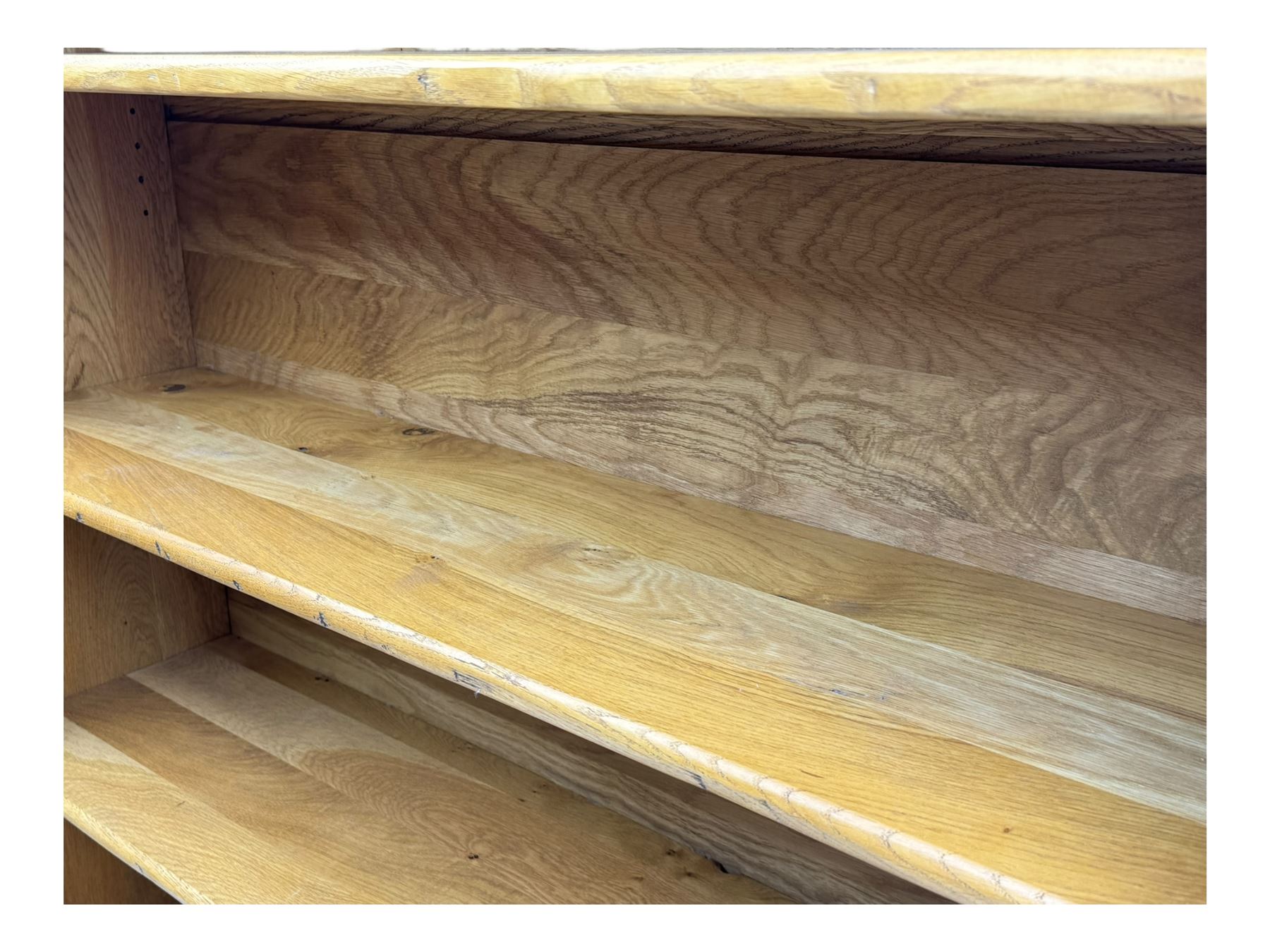 Contemporary French provincial design oak open bookcase, with projecting moulded cornice above a boarded back, fitted with four adjustable shelves, on bracketed plinth base