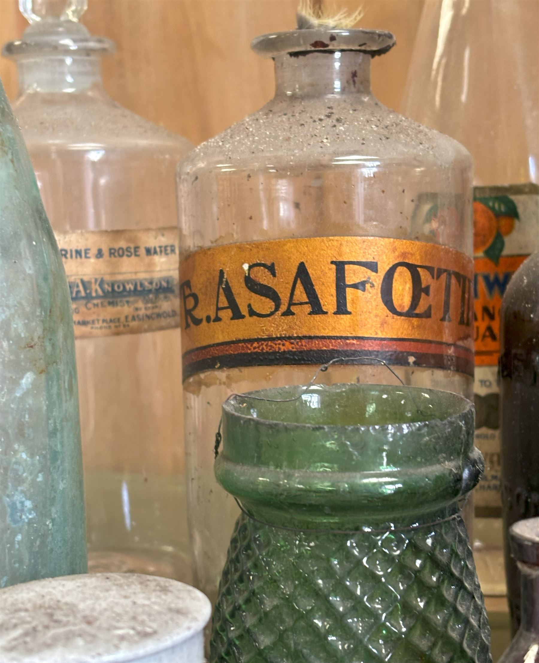 Collection of antique glass bottles and jars, including an apothecary bottle with gilt paper label, three Cranwell drinks bottles, two fish neck bottles, and a group of chemists preparation paste pots.  - COLLECTION BY APPOINTMENT FROM: The White House, Thirsk Road, Easingwold, York, YO61 3NF - CALL 01723 507111 TO ARRANGE