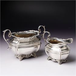 Edwardian silver three piece bachelors tea set of panel sided rectangular form with shell and scroll borders on shell moulded feet London 1903- 1905 Maker Josiah Williams & Co