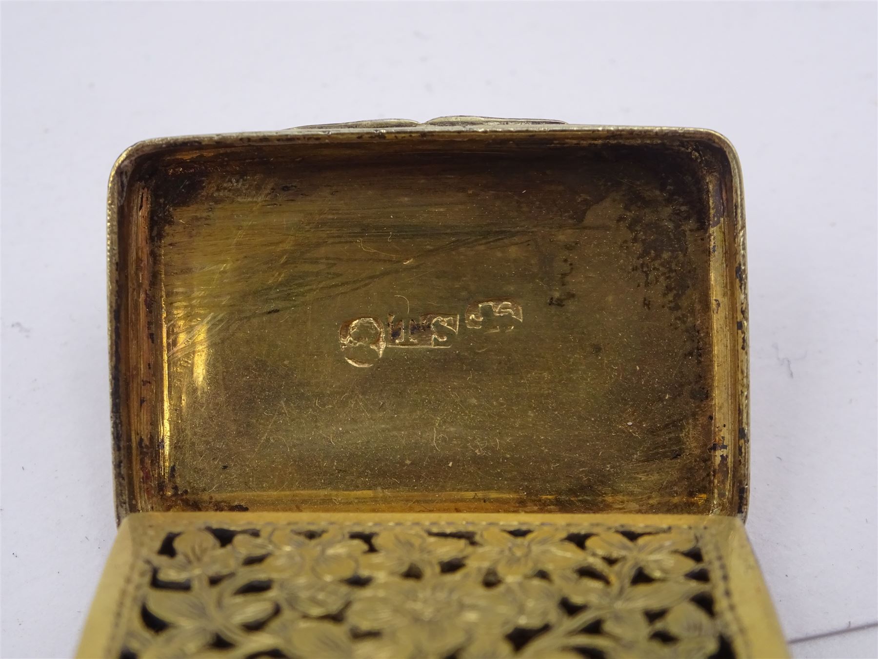 George III silver vinaigrette, of typical rectangular form, with raised foliate rim and engine turned decoration, with banded sides and foliate pierced engraving to gilt interior, hallmarked Birmingham 1797, maker's mark TS, L3cm