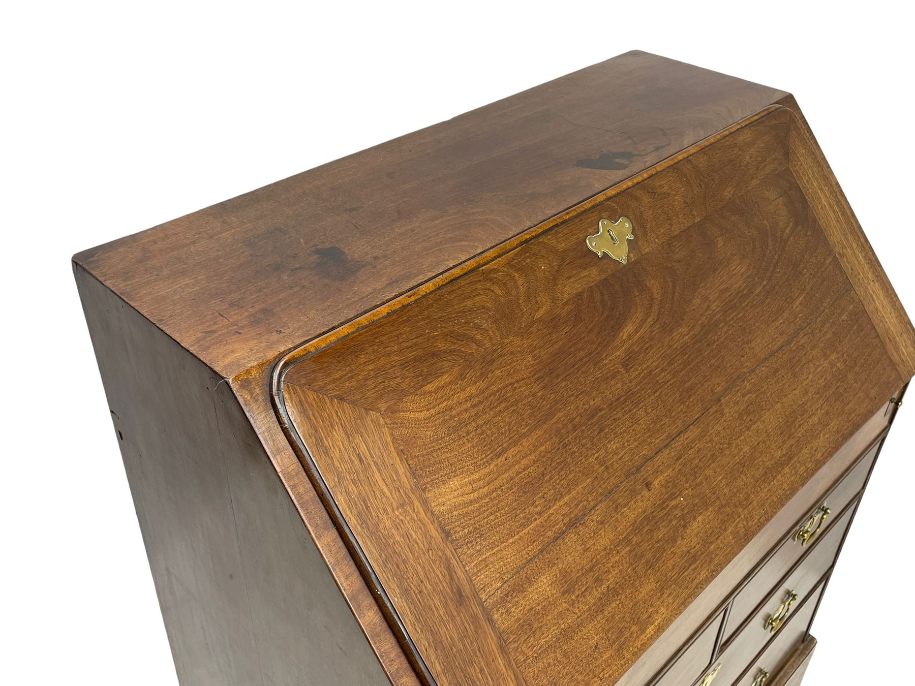 Georgian red walnut and mahogany bureau, moulded rectangular fall front with rounded upper corners, the interior fitted with sliding storage well, a combination of small drawers and pigeons holes, two short and two long drawers below, on bracket feet