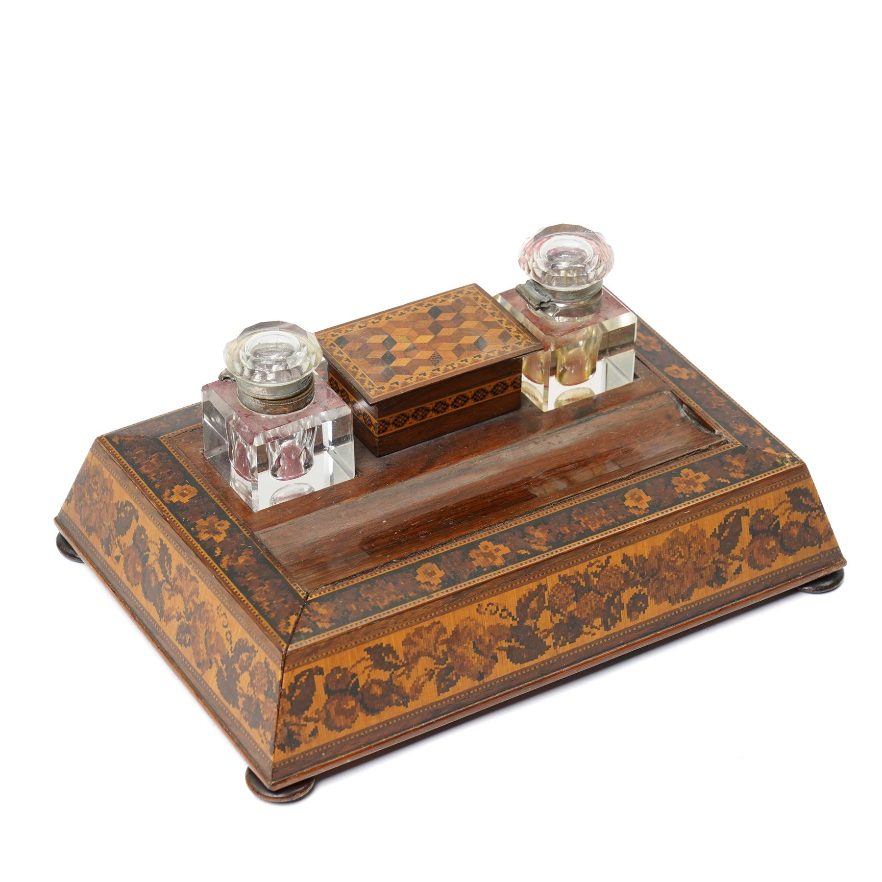 19th century Tunbridgeware inkstand, with two cut glass inkwells, sloping floral mosaic sides, space for pens and covered nib compartment, raised on bun feet, W26cm; together with a pen knife of the same design (2)