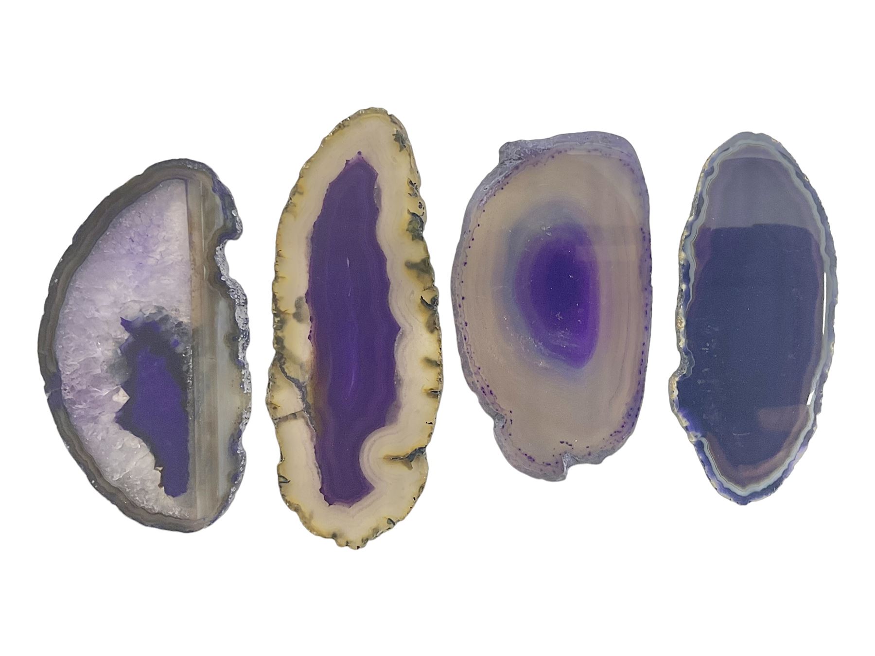 Four purple agate slices of various sizes, polished with rough edges