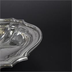 Early 20th century silver swing handled basket, of oval form with shaped rim and upon four bun feet, hallmarked C W Fletcher & Son Ltd, London 1918