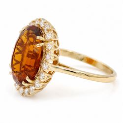 18ct gold citrine and diamond cluster ring, single oval cut citrine of approx 6.90 carat, surrounded by twenty round brilliant cut diamonds, stamped, total diamond weight approx 0.60 carat